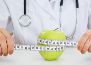 Nurse Measuring Apple photo